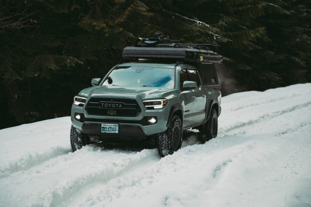 Four Season truck camper in driving in snow in winter