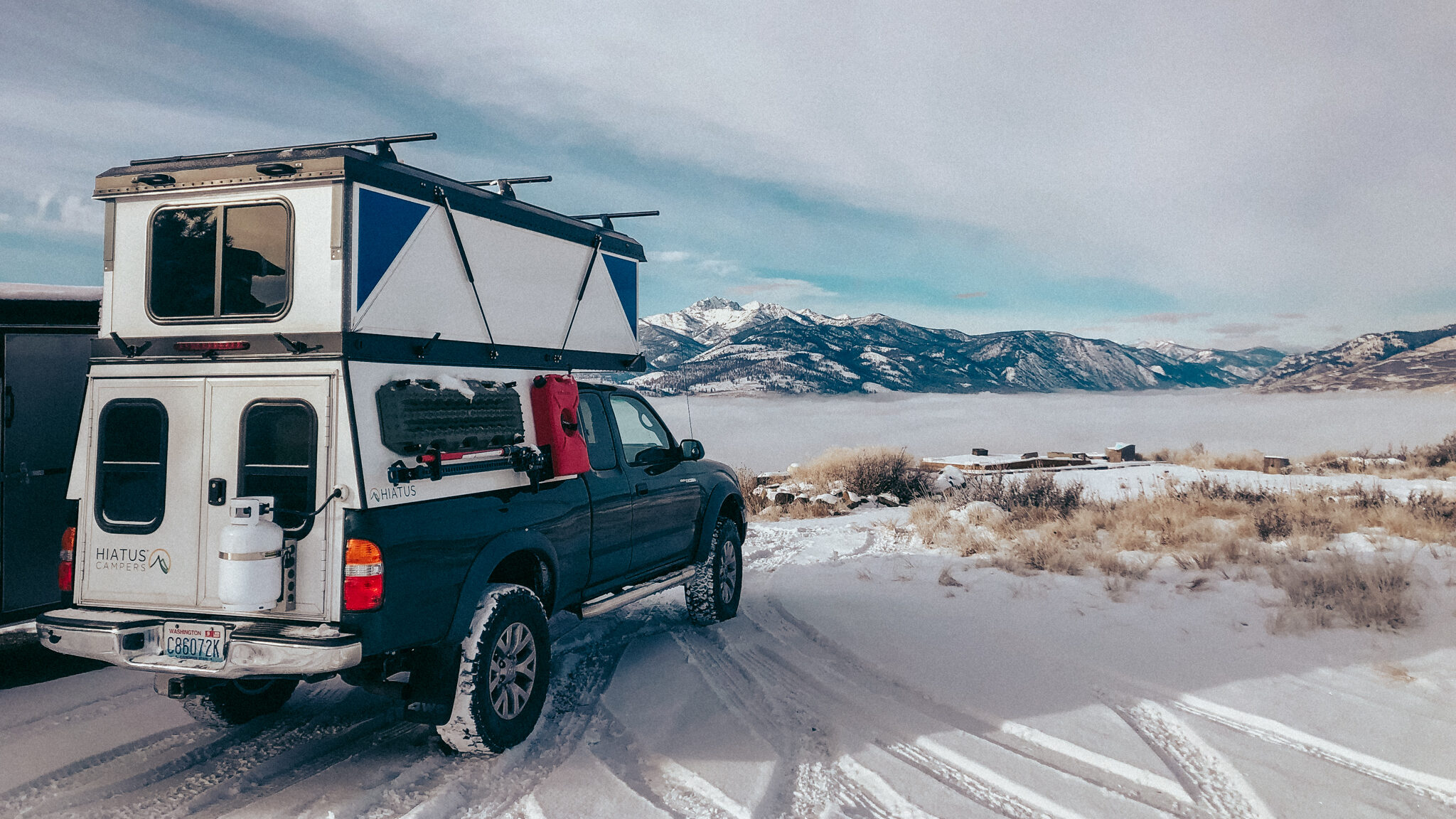 four season truck camper parked in snow during winter camping
