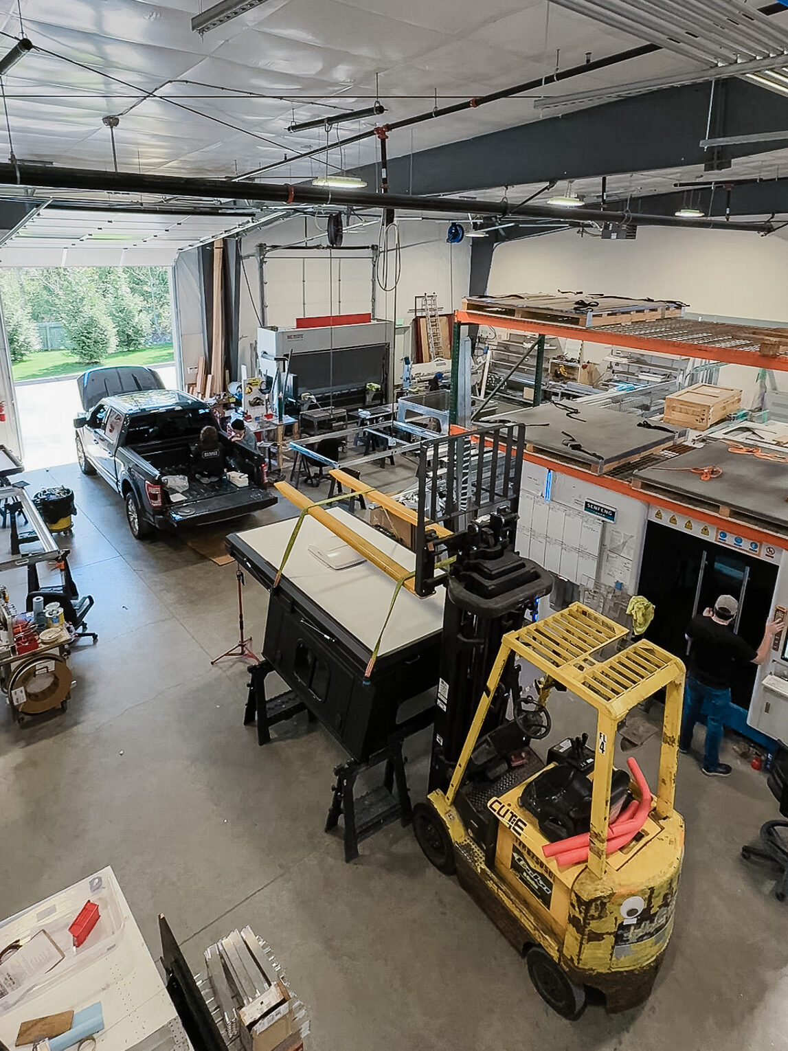 A truck camper being installed at Hiatus Campers